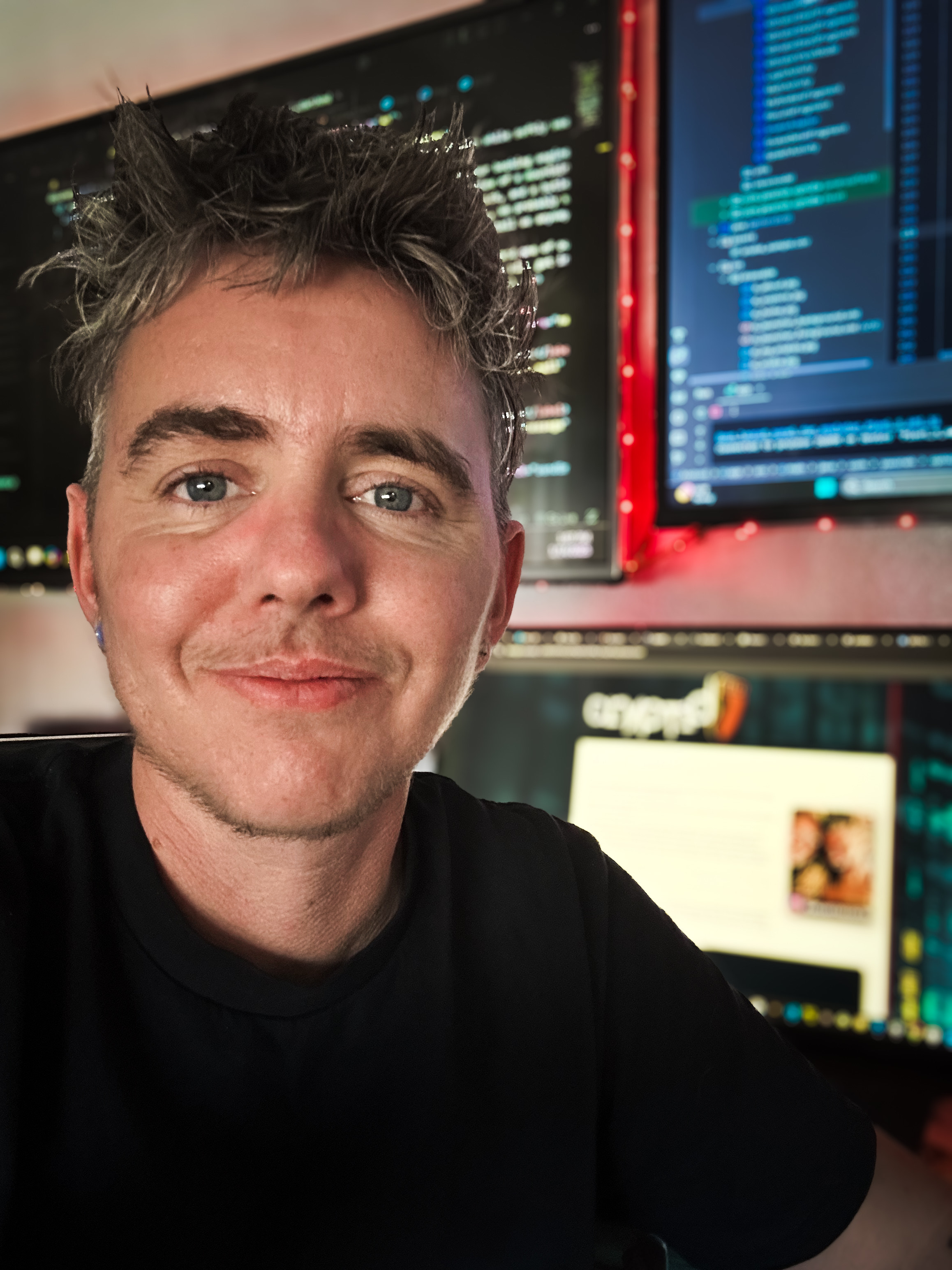 Current photo of Aiden in front of his coding setup.